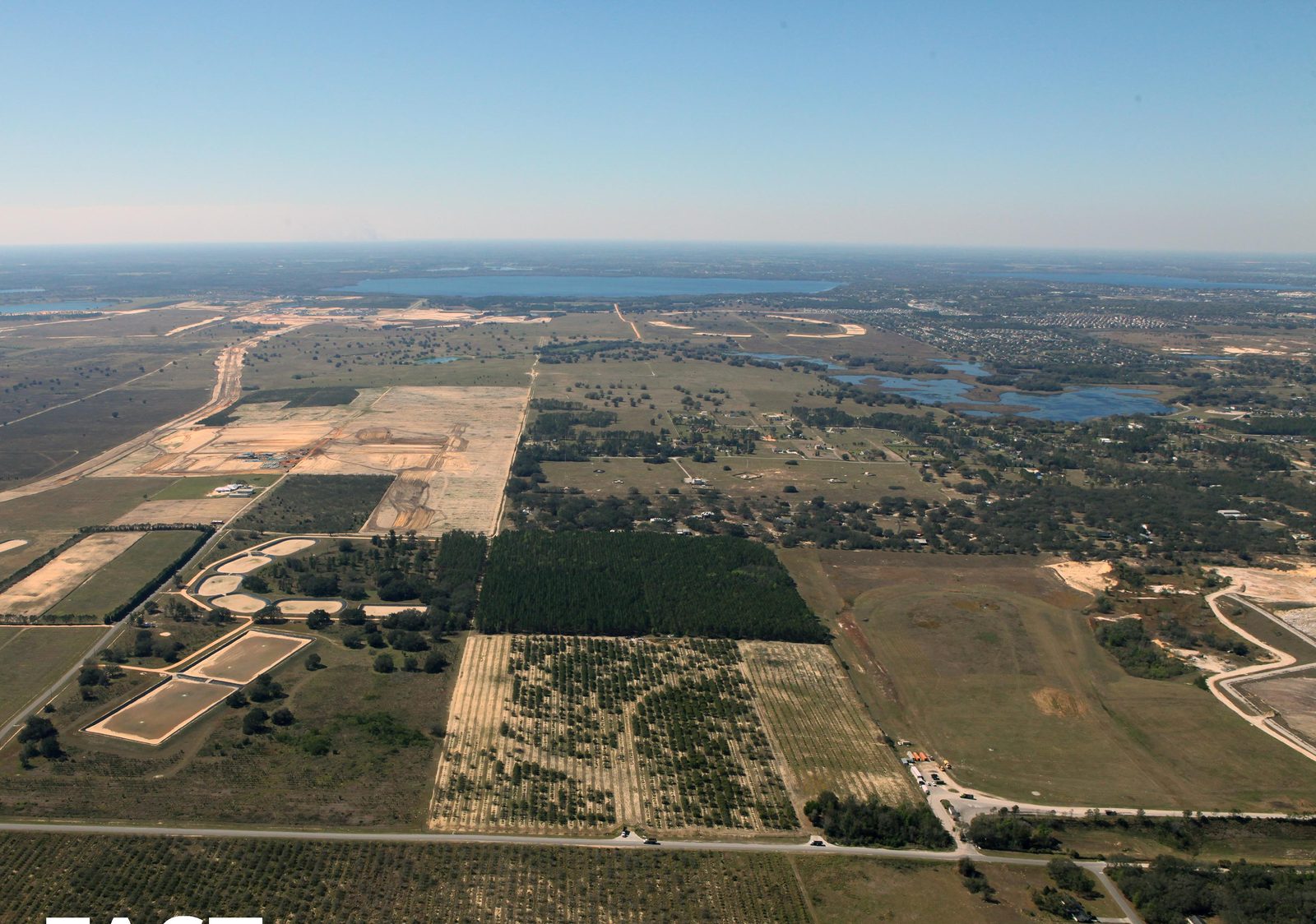 Aerial context · pine + citrus + Disney corridor on horizon